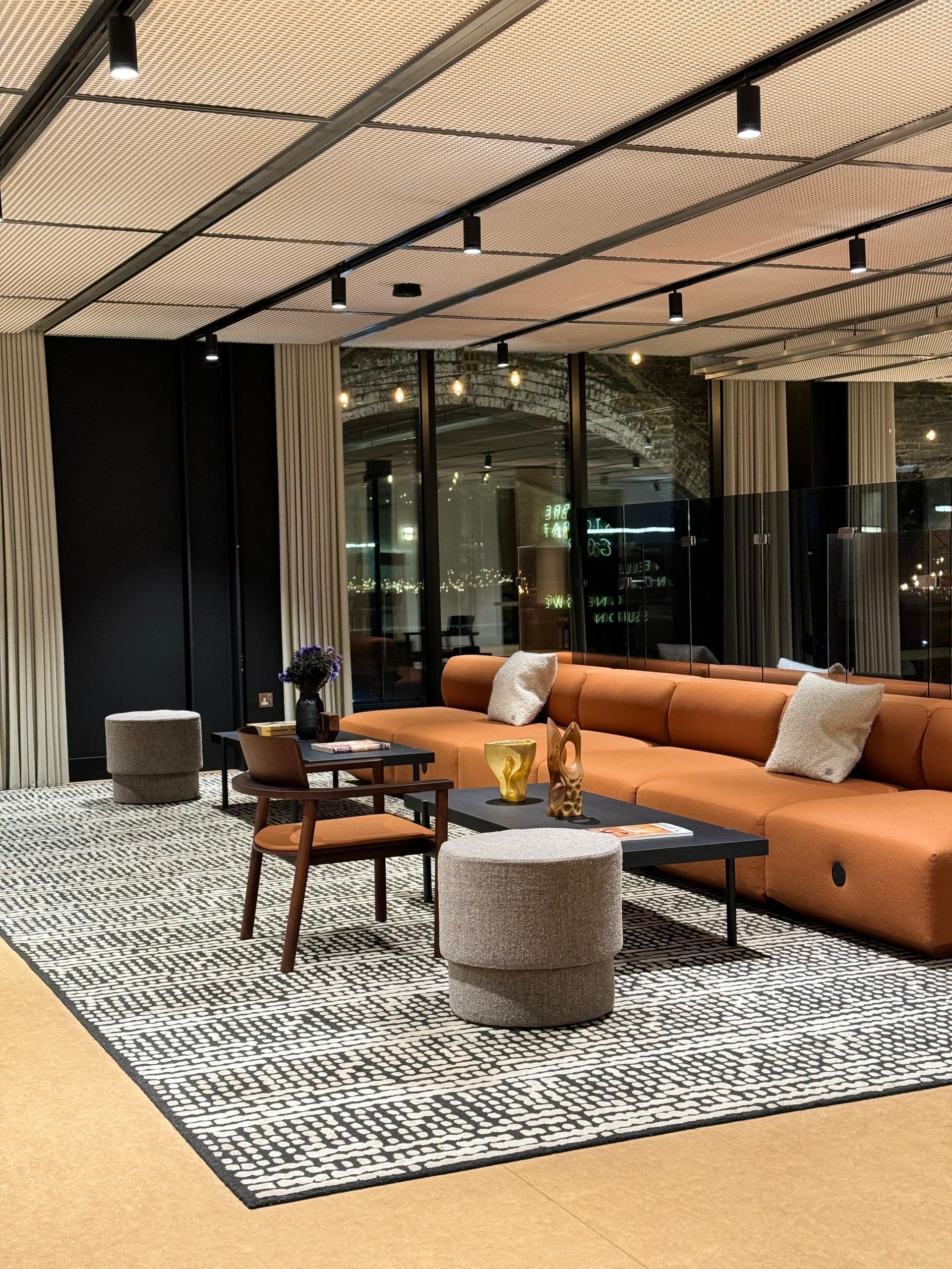 A Najmat living room with a low sofa, stone table, and linen curtains